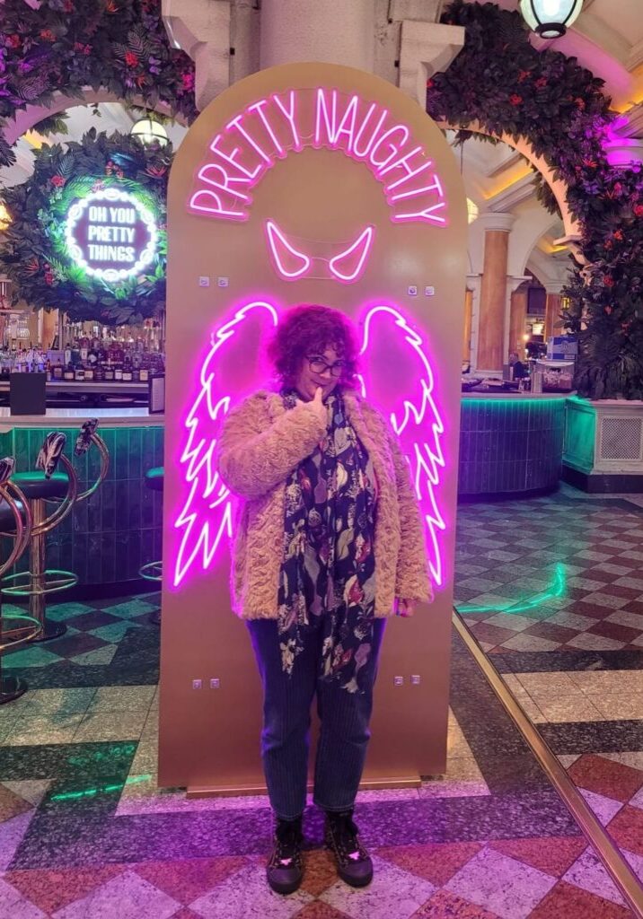 Woman with neon pink wings. Learn to trust yourself using Human Design
